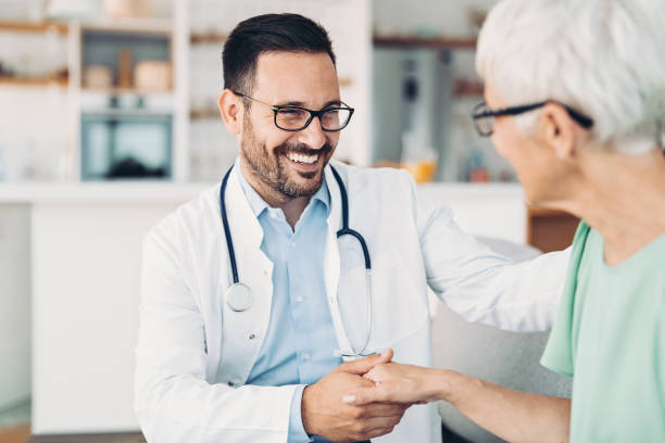 Smiling doctor with senior patient stock photo