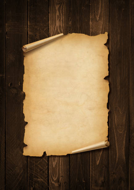 istock Old mediaeval paper sheet. Parchment scroll on a wood board 1368151144