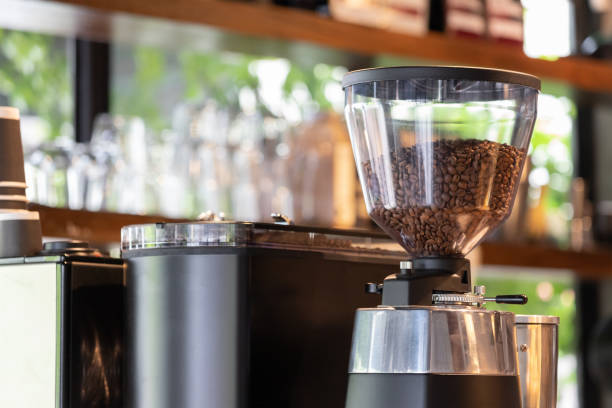 istock Coffee beans inside the machine hopper in cafe. 1368151159