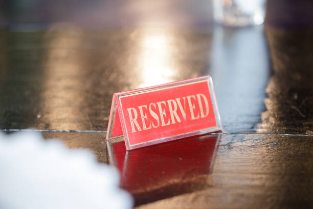 istock reserved sign on black wooden table in restaurant. 1368151175