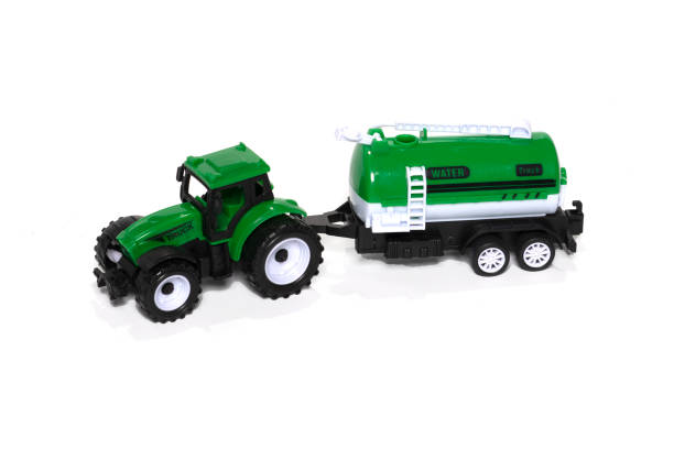 istock Green toy tractor with water trailer isolated on white background. 1368151252