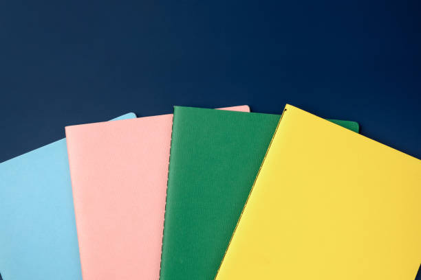 istock top view pastel notebook with pencil and stationery on navy blue table background 1368152162
