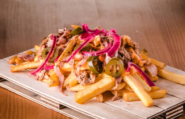 istock Loaded french fries with pulled pork, jalapenos, cheddar sauce and onion 1368155667