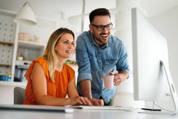 istock Happy couple doing business together working at small office 1368156578