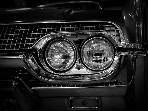 Headlight of an old muscle car, close-up.