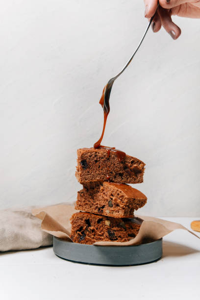 istock chocolate brownie with nuts and almond on a white background 1368157037