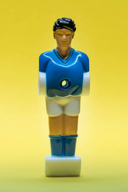 Table soccer figure isolated on yellow background