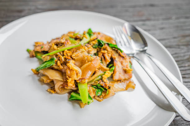 istock Stir fried flat noodle and pork with dark soy sauce 1368157753