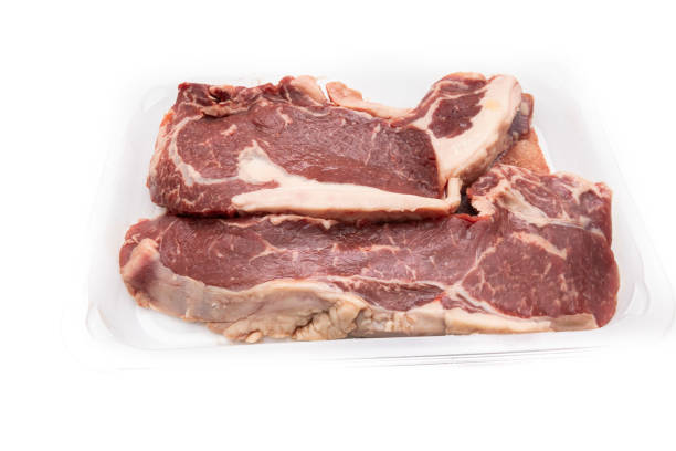 istock Two finger-thick ribeyes, tucked into a clear plastic tray 1368157852