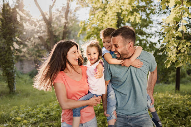 istock Cheerful family having fun during spring day at the park. 1368157866