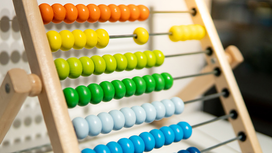 Wooden calculating eads on rainbow abacus for number calculation. Mathematics learning concept
