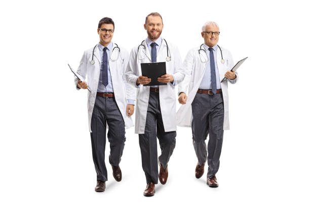 three male doctors smiling and walking towards camera - portrait doctor paramedic professional occupation imagens e fotografias de stock