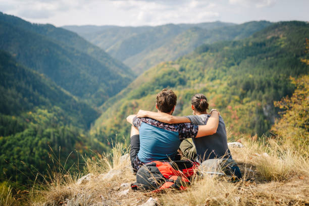 Happy young friends / gay couple in the mountain.