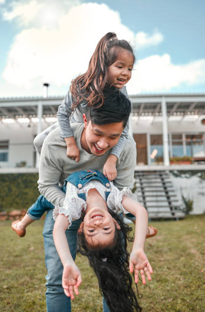 istock Shot of a father bonding with his two young daughters outside 1368162967