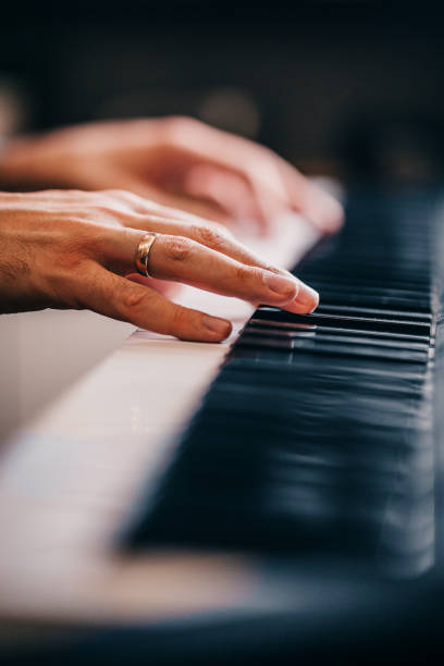 istock Caucasian man presses piano keys 1368163582