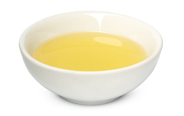 istock Small bowl with olive oil isolated on white background 1368163626