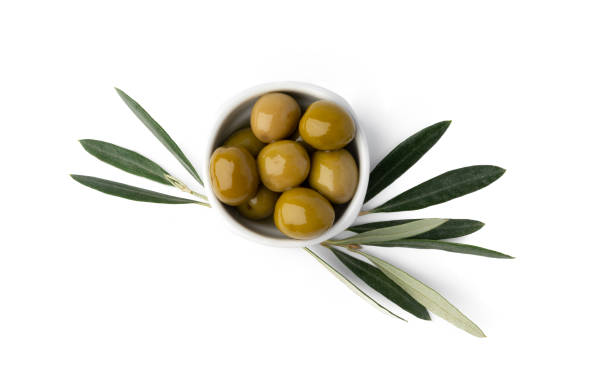 istock Bowl with green olives and olive leaves on white background 1368165178