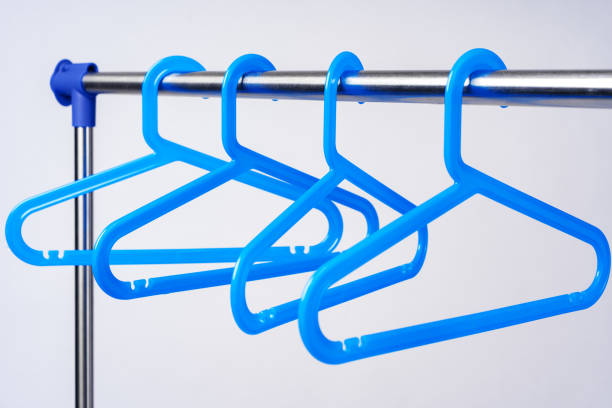 istock Metal rack with clothes hangers on white background 1368165277
