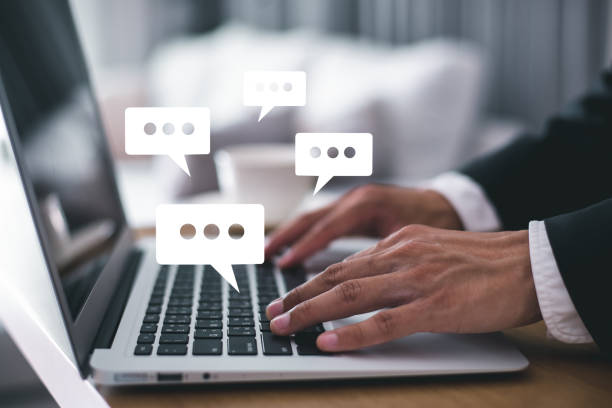 istock Businessman in suit using computer laptop with chat icon on wood desk. Online live and chatting on application communication digital media website and social network. 1368166313
