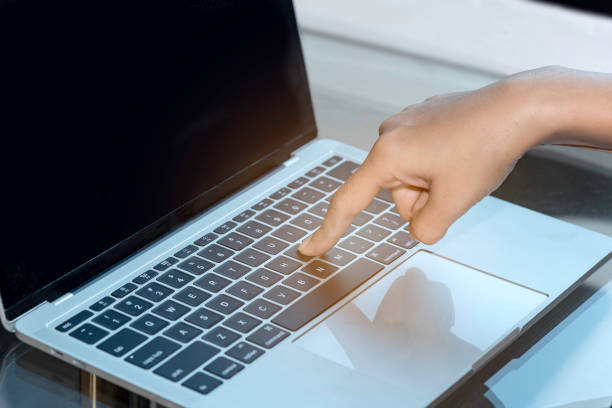 istock close up of finger press laptop keyboard. 1368168622