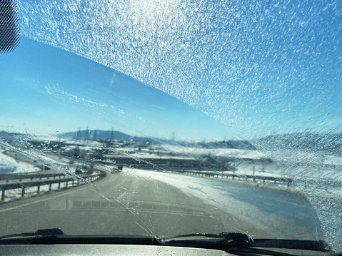 Driving with dirt glass car window and sunlight reflection with road background