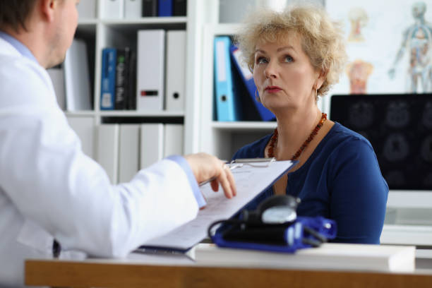 Doctor interviewing elderly woman patient in clinic office Doctor interviewing elderly woman patient in clinic office. Taking medical anamnesis concept anamnesis stock pictures, royalty-free photos & images