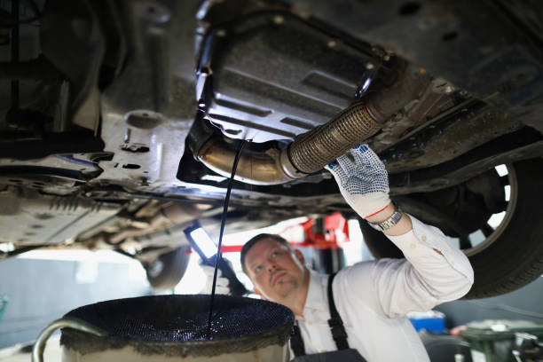 istock Man repairman fixing car in workshop closeup 1368169068