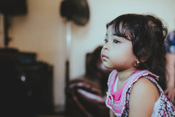istock baby boy  and his sister  watching television 1368171467