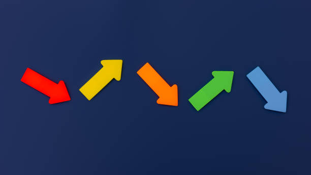 istock Colorful paper arrows on dark blue background. Top view, direction arrows 1368171506