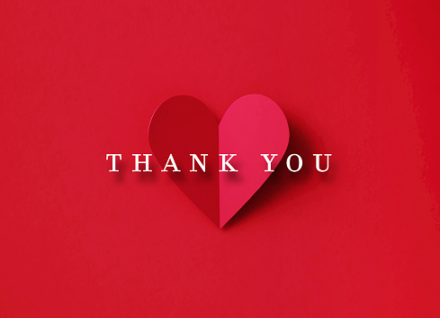 Thank You message over a folding red heart shape on red background. Horizontal composition with copy space. Directly above. Thank You concept.