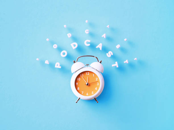 istock Podcast Message Sitting Above White Alarm Clock On Blue Background 1368173242