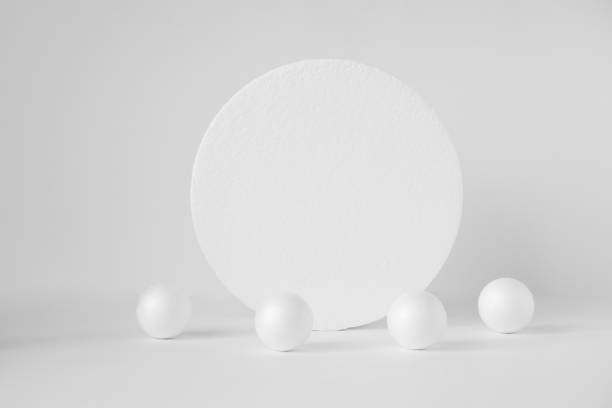 istock Round 3d stand surrounded by randomly scattered balls. Concept of geometric composition on white isolated background 1368174035