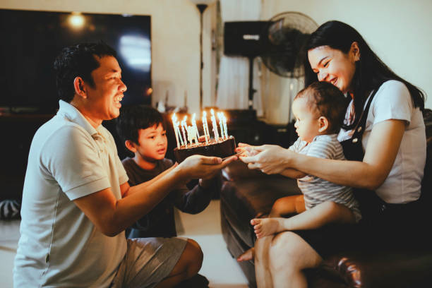 istock husband Presenting wife with Birthday Cake 1368177060