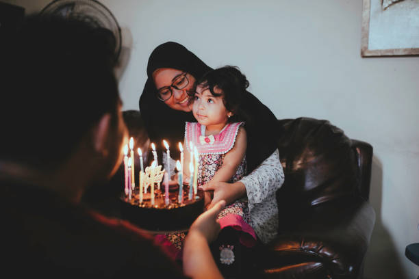 istock husband Presenting wife with Birthday Cake 1368177083