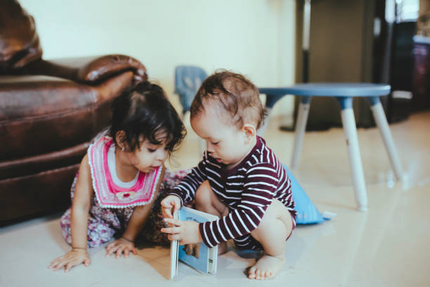 istock two babies playing together at home 1368177166
