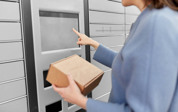 istock smiling woman with box at automated parcel machine 1368177605