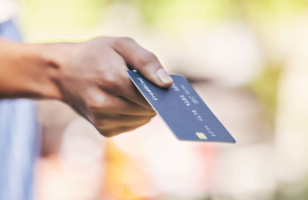 istock Shot of a woman making a purchase using her card 1368179200
