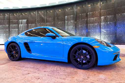 Palm Beach, Florida USA - March 22, 2021: bright blue Porsche 718 Cayman luxury sport car in palm beach, united states of america. side view. Porsche is luxury car brand