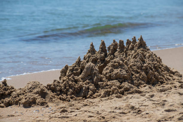sand castle on the beach near the water.
