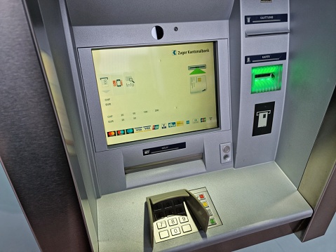 An ATM of the Zuger Kantonalbank. The image shows a close up of an ATM machine in Zug City.