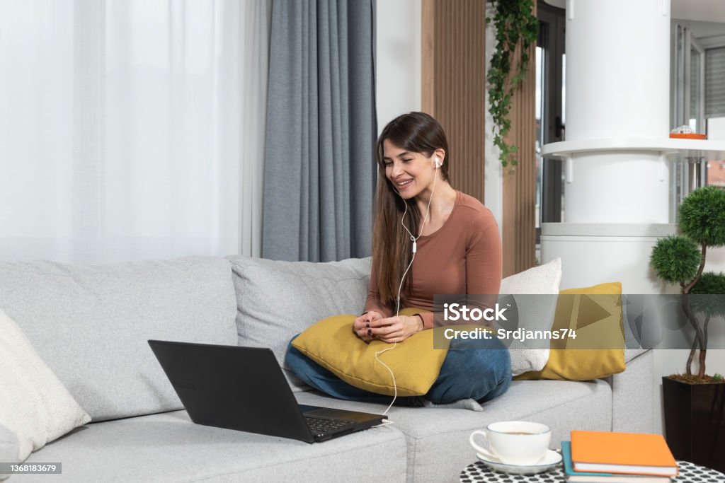 Young woman talking on video call with her psychotherapist doctor after online therapy sessions, happy that she is well and mentally health now after telemedicine conversations. Online Therapy Stock Photo