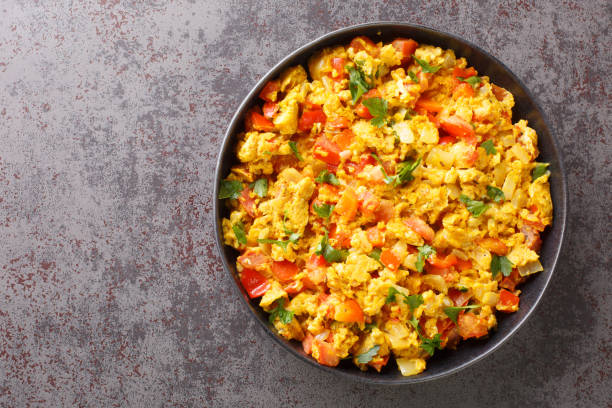 istock Classic Indian breakfast, egg Bhurji is a spicy mouth watering spin on scrambled eggs closeup in the plate. Horizontal top view 1368188228