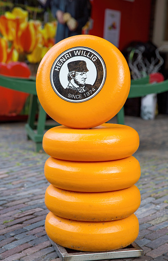 Amsterdam, Netherlands - 7th July 2014: A stack of Gouda cheese outside of the Henri Willig store in Amsterdam. A Dutch cheesemaker since 1974.