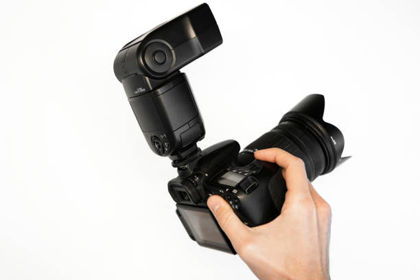istock man holding reflex camera with on-camera flash on white background top view 1368188788