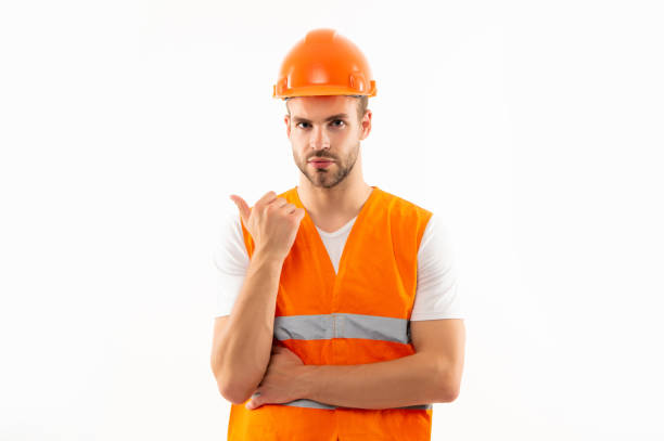 istock man in orange reflective vest and helmet point finger isolated on white background, engineer 1368190045