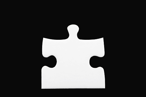 One white puzzle piece isolated on black background