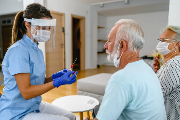 istock Female doctor taking a nose swab test from a senior man for COVID-19 testing testing 1368190269