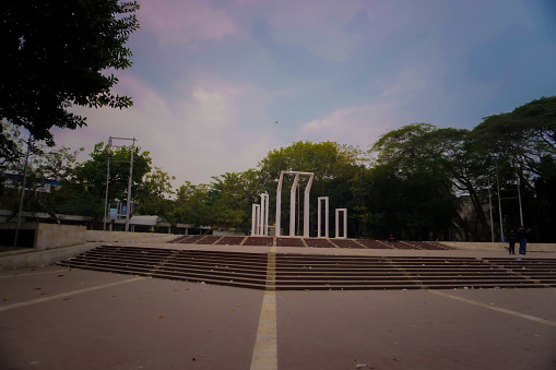 The photo was taken on 14th of January 2022 at morning containing Shaheed Minar. The first Shaheed Minar was built immediately after the events of 21–22 February 1952. According to Dr. Sayeed Haider the main planner and the designer of the first Shaheed Minar, the decision to build it was first made by the students of Dhaka Medical College. Shaheed Minar is situated near Dhaka Medical College Hospital and in the Dhaka University area.