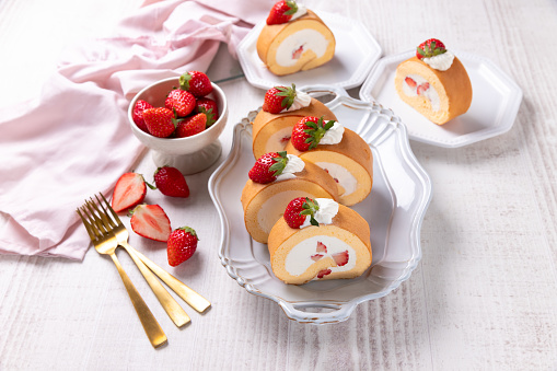 Strawberry swiss roll cake with whipped cream