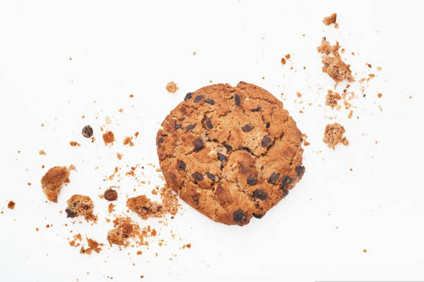 istock Stack of chocolate chip cookies and crumbs on white background. Top view. 1368191569